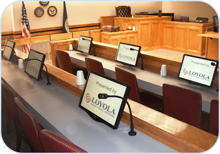 A courtroom with laptops on the desk