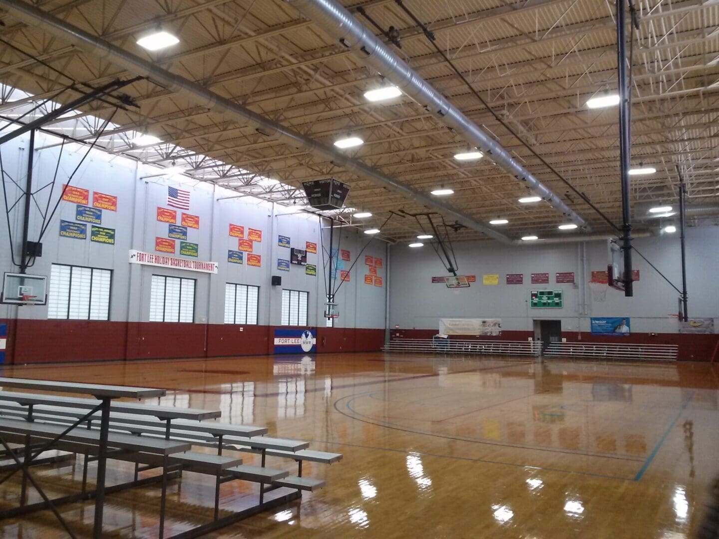 A gym with benches and bleachers in it