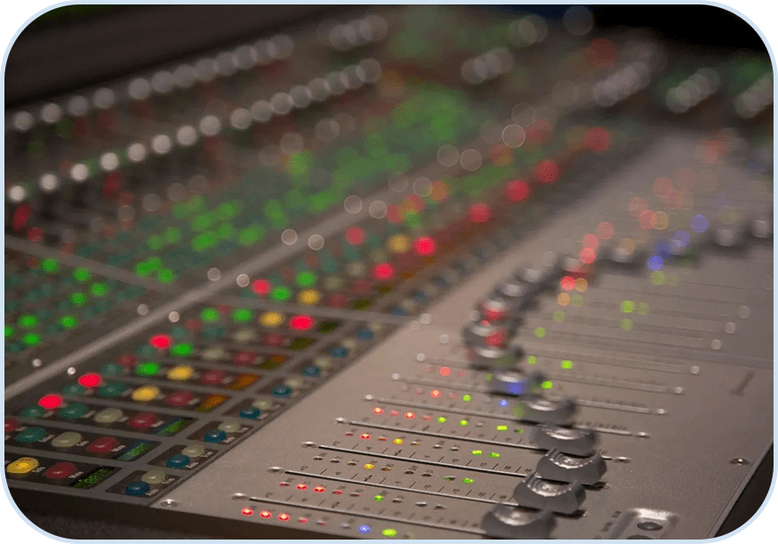 A close up of the sound board of an audio mixer