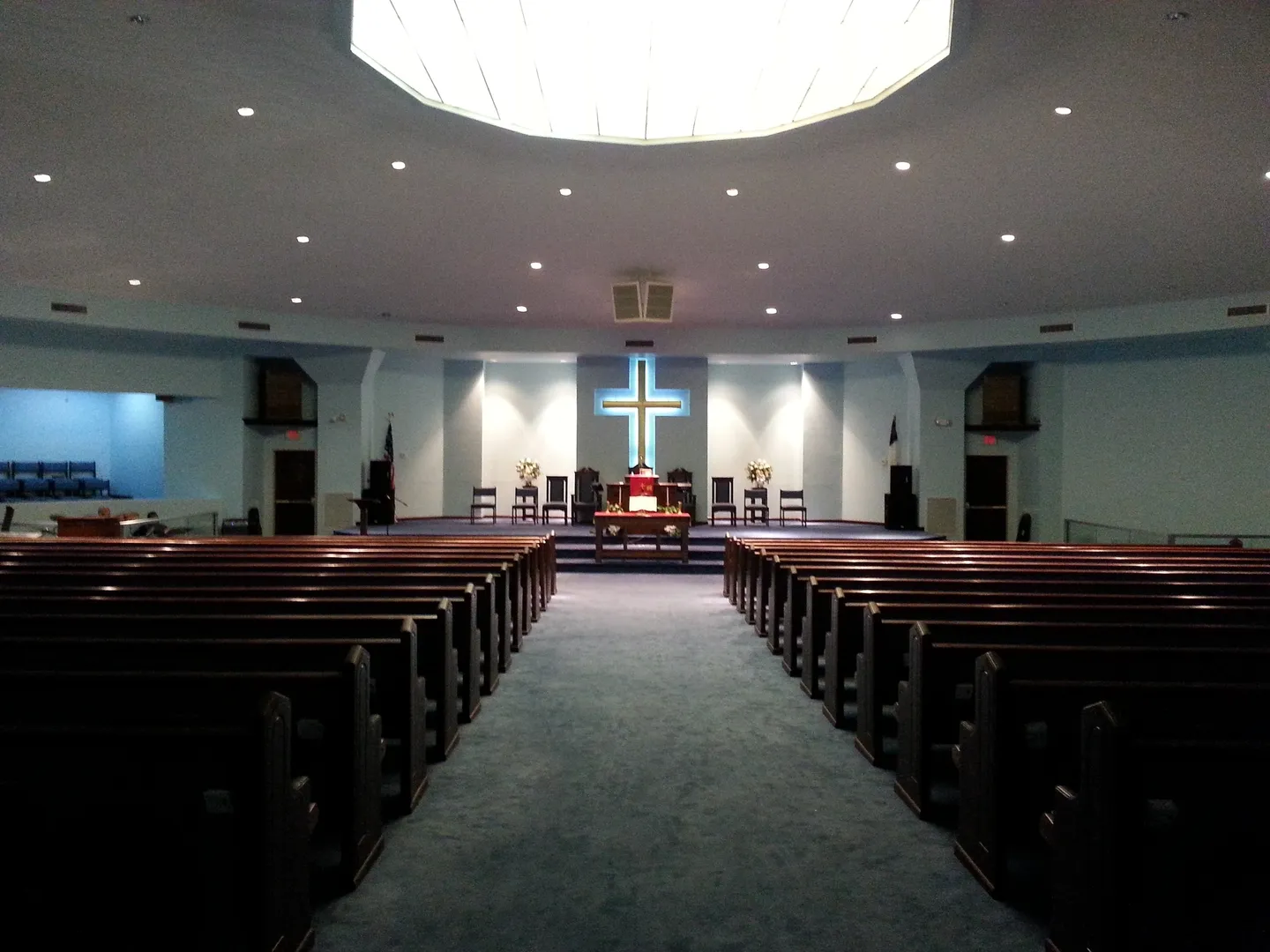 A church with pews and a cross in the center.