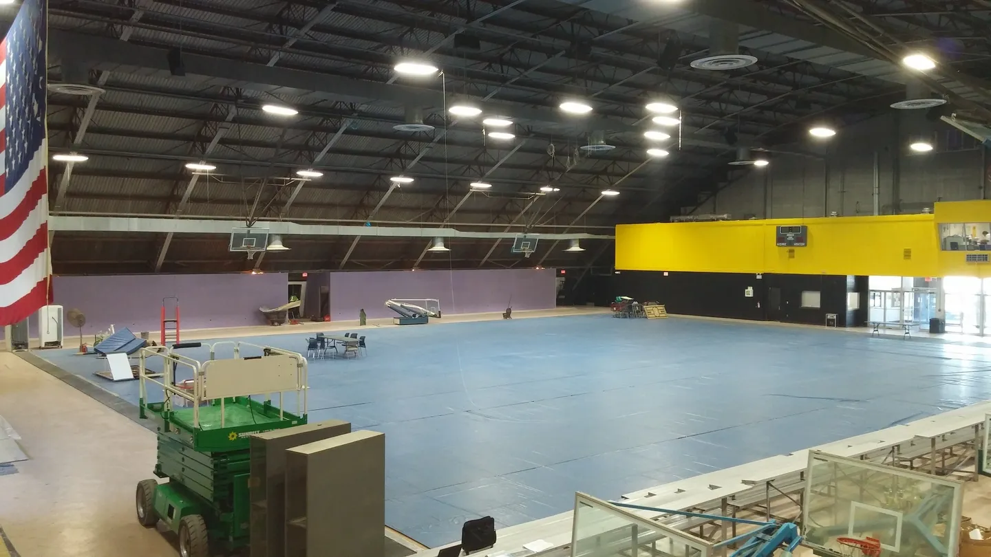 A large indoor arena with many boxes in it.