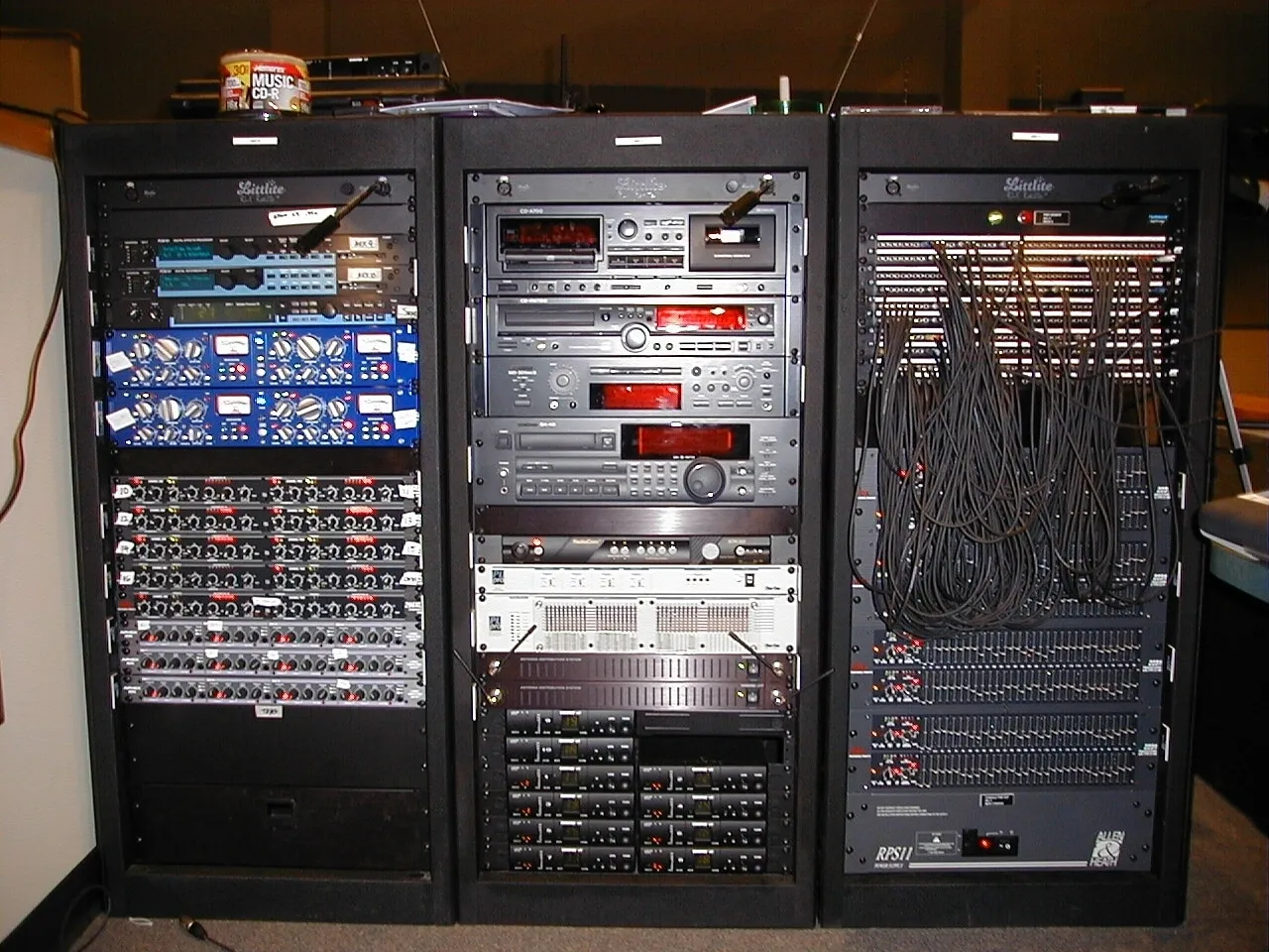 A large rack of computer equipment sitting on top of a floor.