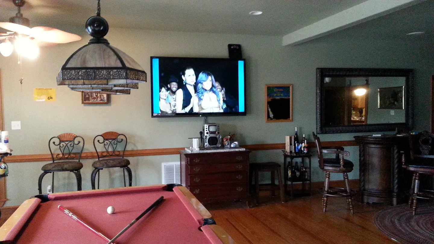 A pool table and tv in the room