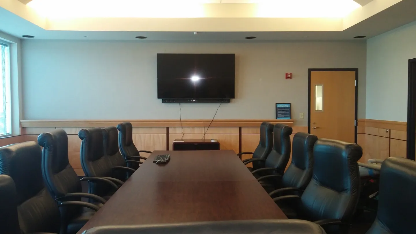 A large conference room with a big screen tv.